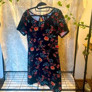 Very dark green floral patterned dress.